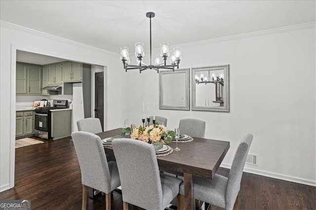 dining space featuring a chandelier, dark wood-type flooring, and ornamental molding