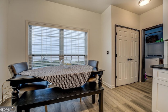 dining area featuring washer / clothes dryer and light hardwood / wood-style flooring