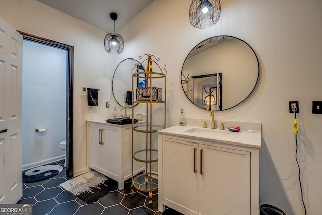 bathroom featuring vanity, tile patterned floors, and toilet