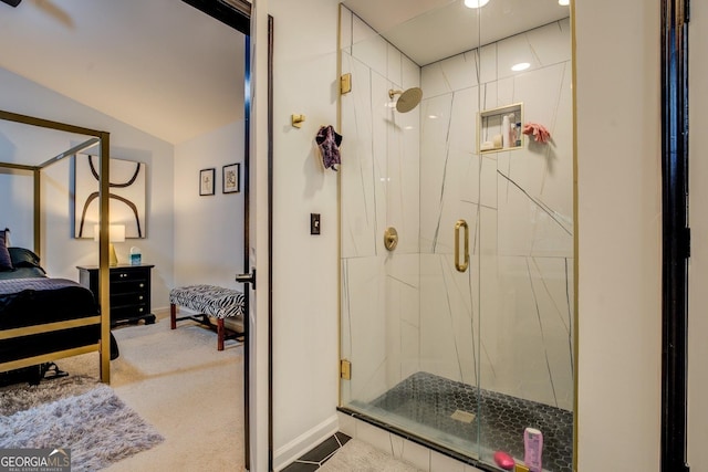 bathroom featuring lofted ceiling and walk in shower