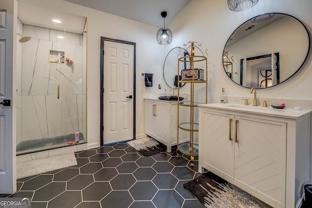 bathroom featuring a shower with door, vanity, and tile patterned flooring