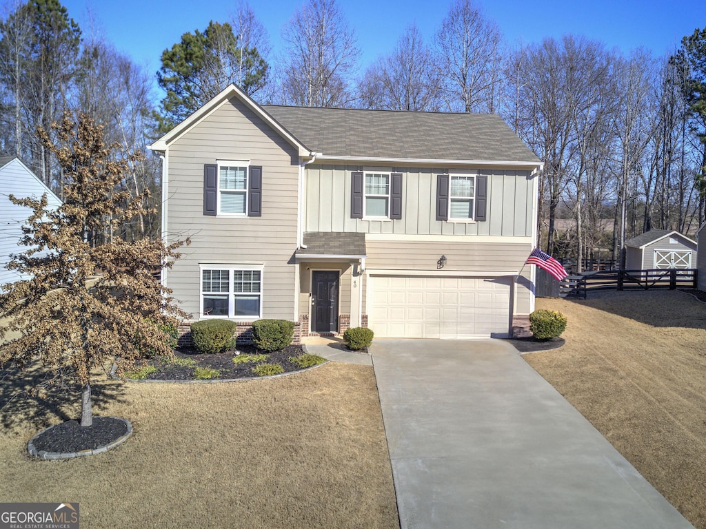 view of front of home featuring a front yard and a garage