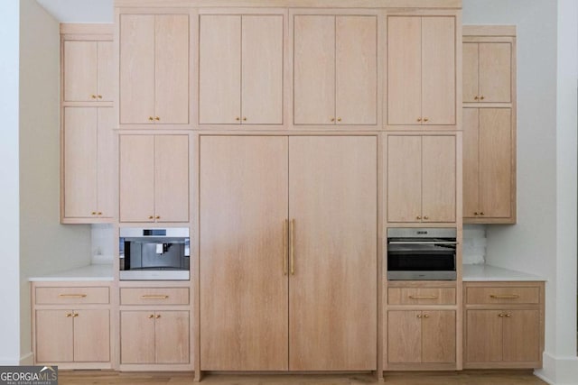 kitchen featuring light brown cabinets and stainless steel oven