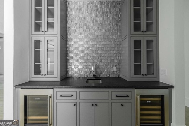 bar featuring decorative backsplash, white cabinets, wine cooler, and sink