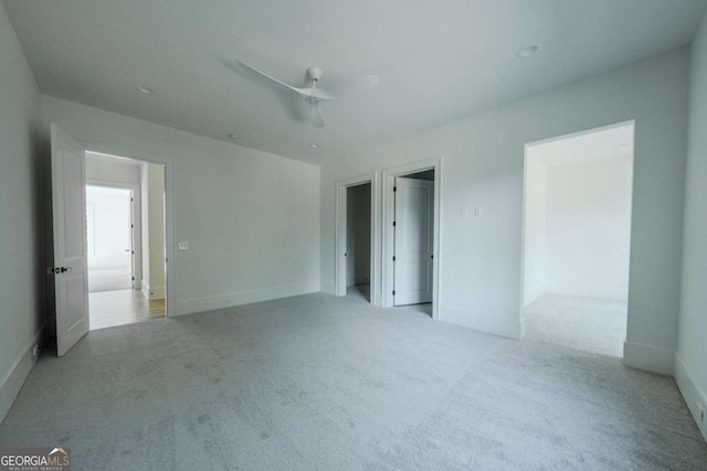 unfurnished bedroom with light colored carpet and ceiling fan