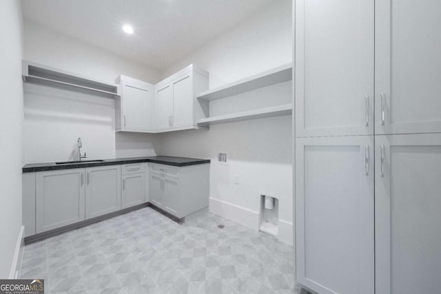 laundry area with cabinets, sink, and hookup for a washing machine