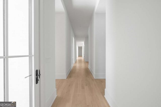 hall with light hardwood / wood-style flooring