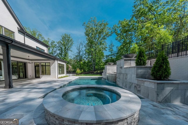 view of swimming pool with an in ground hot tub and a patio