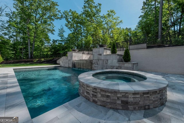 view of swimming pool featuring an in ground hot tub