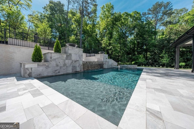 view of swimming pool with a patio