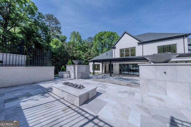 view of patio with a fire pit