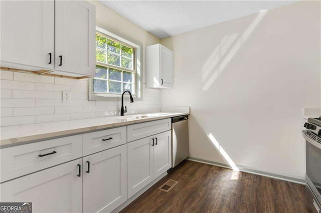 kitchen featuring white cabinets, sink, light stone countertops, and stainless steel appliances