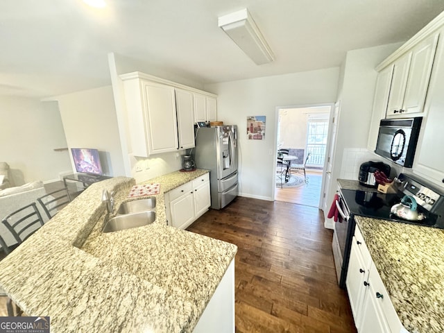 kitchen with white cabinets, light stone counters, sink, and stainless steel appliances