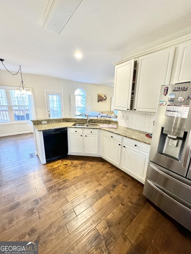 kitchen featuring white cabinetry, kitchen peninsula, stainless steel fridge, and black dishwasher