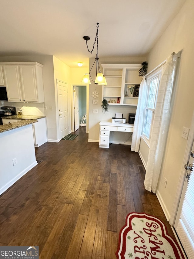 kitchen featuring light stone counters, decorative light fixtures, dark hardwood / wood-style flooring, white cabinetry, and a chandelier