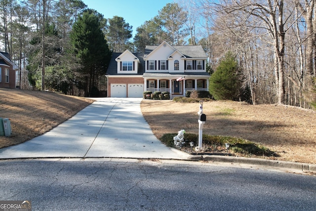 view of front of property featuring covered porch and a garage