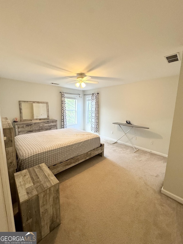 carpeted bedroom with ceiling fan