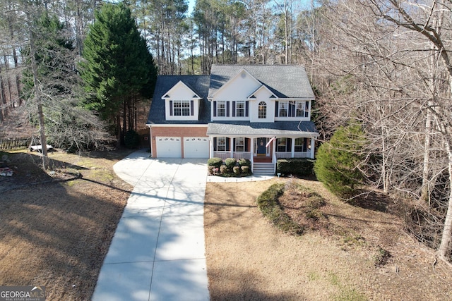 view of front of house with a porch and a garage