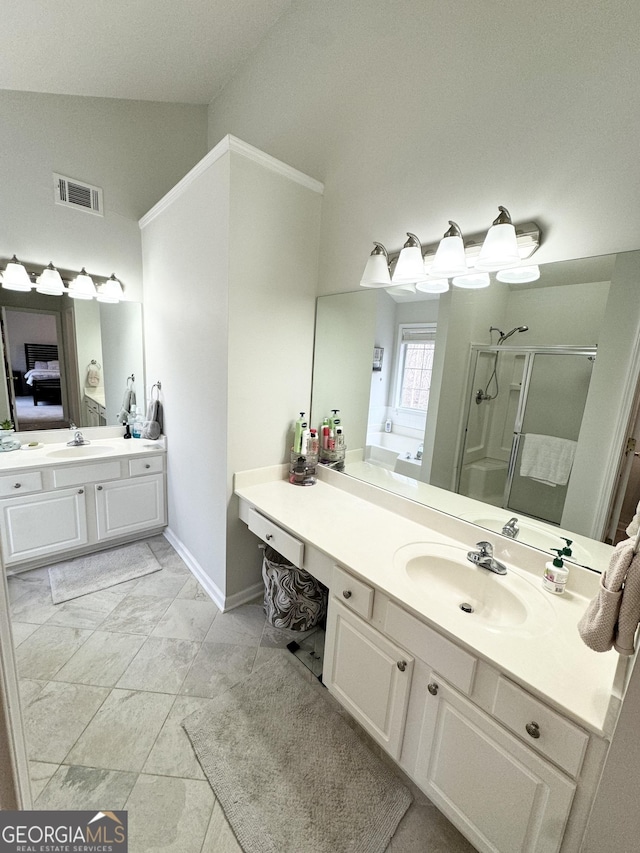 bathroom featuring tile patterned flooring, vanity, a shower with door, and lofted ceiling