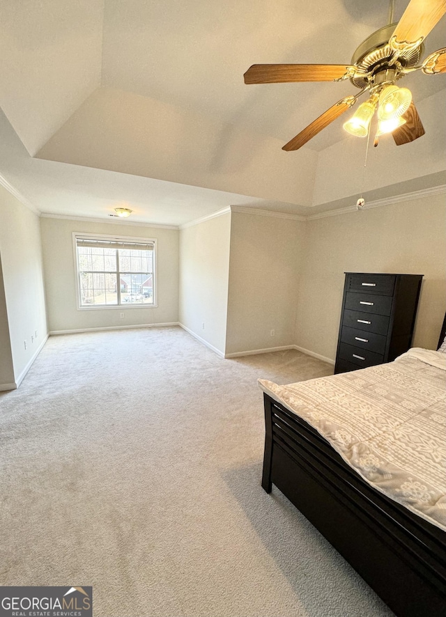 bedroom featuring carpet floors, a raised ceiling, ceiling fan, and ornamental molding