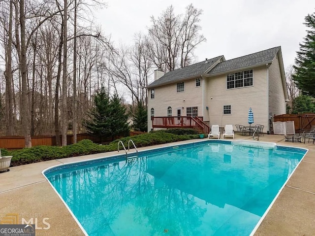 view of pool featuring a deck and a patio area