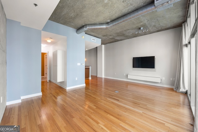 unfurnished living room with light hardwood / wood-style flooring