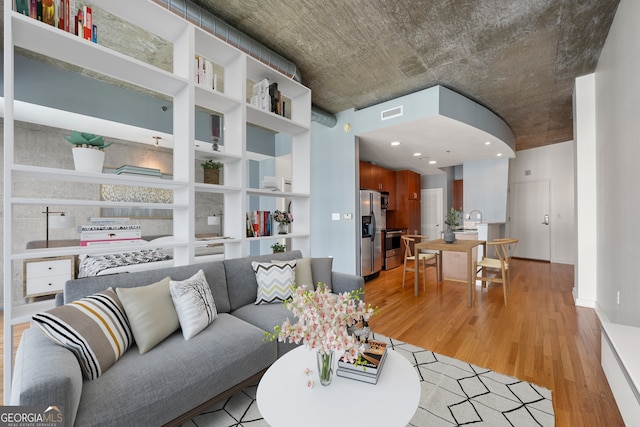 living room with light hardwood / wood-style floors and sink