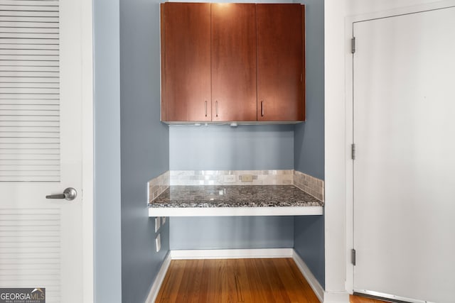 kitchen featuring hardwood / wood-style floors and dark stone countertops