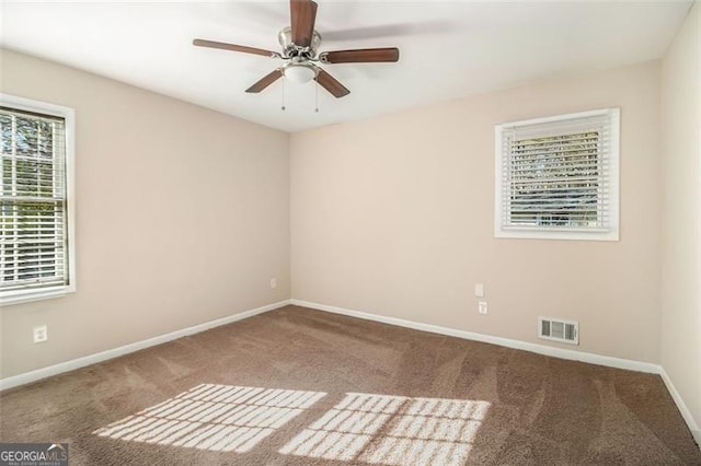 empty room with ceiling fan and carpet floors