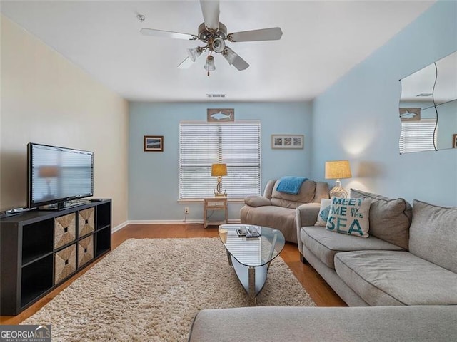 living room with wood-type flooring and ceiling fan