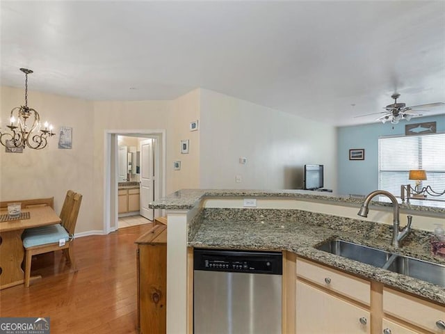 kitchen featuring stainless steel dishwasher, ceiling fan with notable chandelier, sink, light hardwood / wood-style flooring, and hanging light fixtures