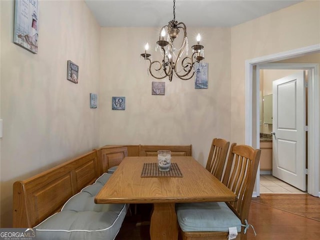 tiled dining area with an inviting chandelier