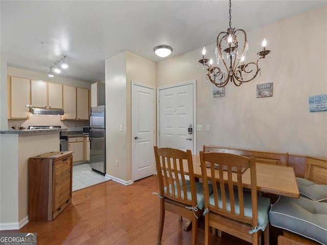 dining area featuring a notable chandelier and light hardwood / wood-style flooring