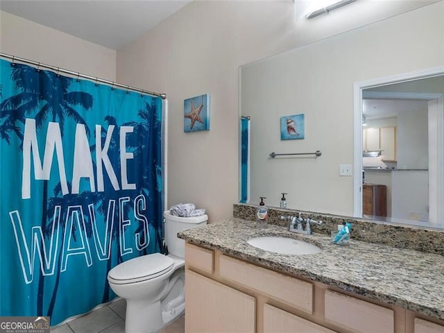 bathroom featuring tile patterned floors, vanity, and toilet