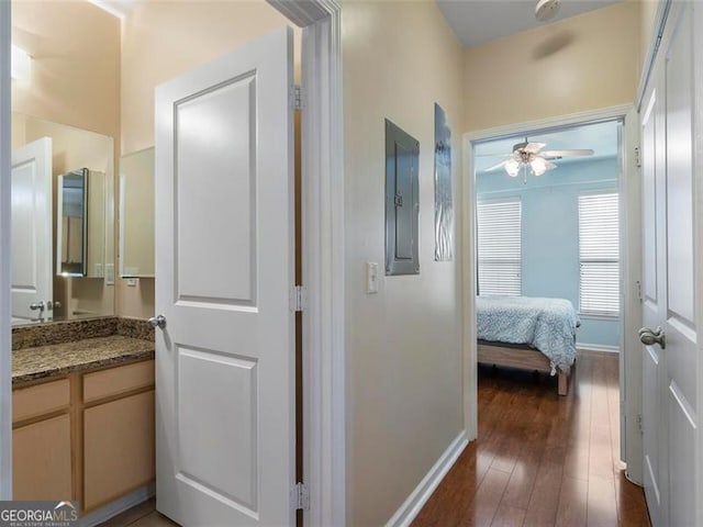 hallway featuring electric panel and dark hardwood / wood-style floors