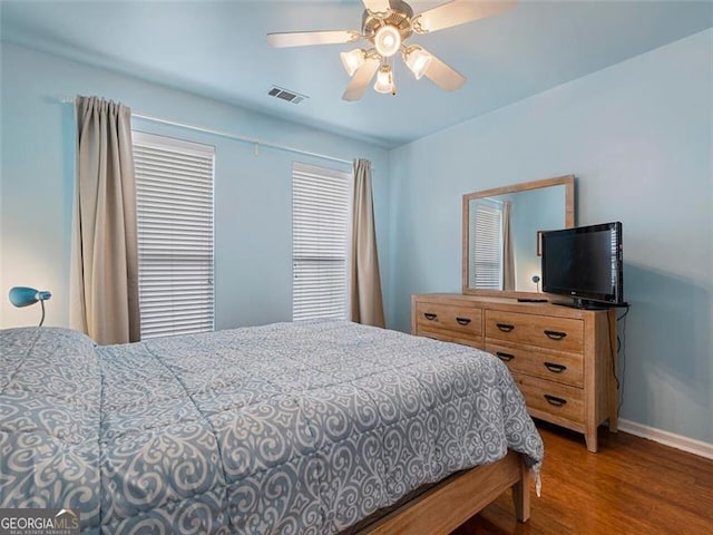 bedroom featuring ceiling fan and dark hardwood / wood-style floors