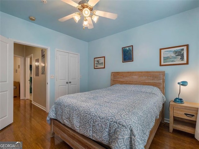 bedroom featuring ceiling fan, a closet, and wood-type flooring