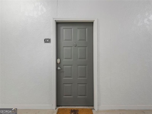 property entrance featuring stucco siding