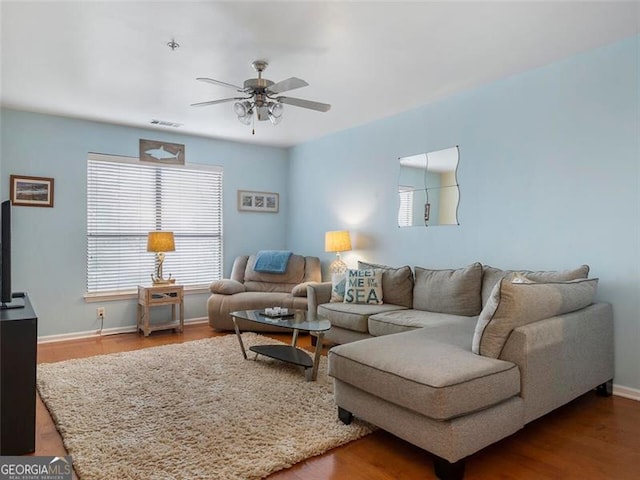 living room with ceiling fan and hardwood / wood-style flooring