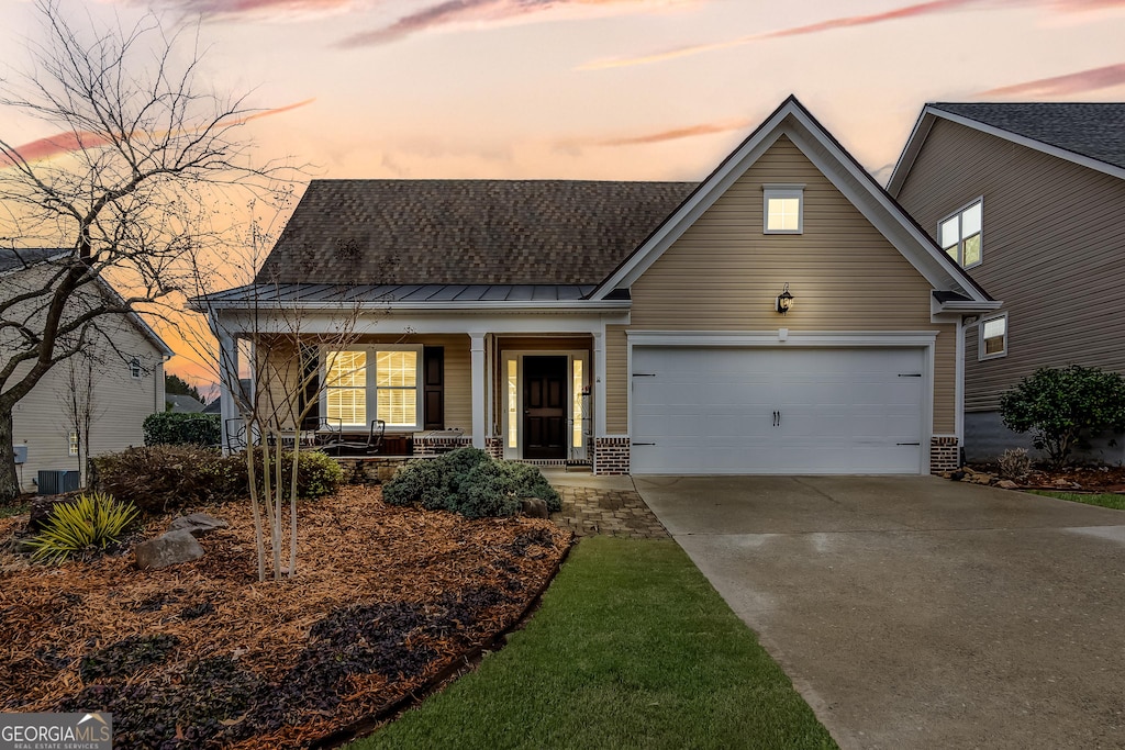 view of front of home with a porch and a garage