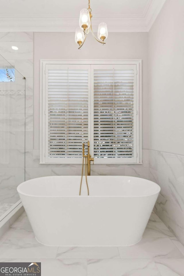 bathroom with independent shower and bath, ornamental molding, tile walls, and a notable chandelier