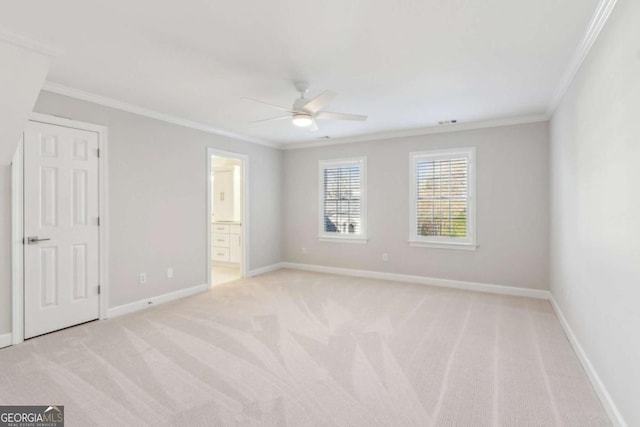 carpeted empty room with ceiling fan and crown molding