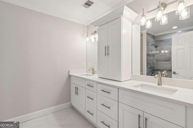 bathroom with a tile shower, vanity, and ornamental molding