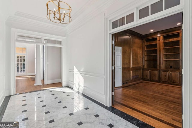 interior space with crown molding and an inviting chandelier