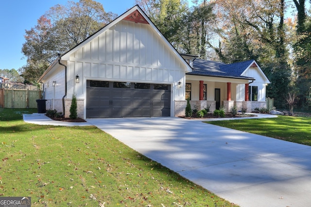 modern farmhouse style home featuring a front yard and a garage