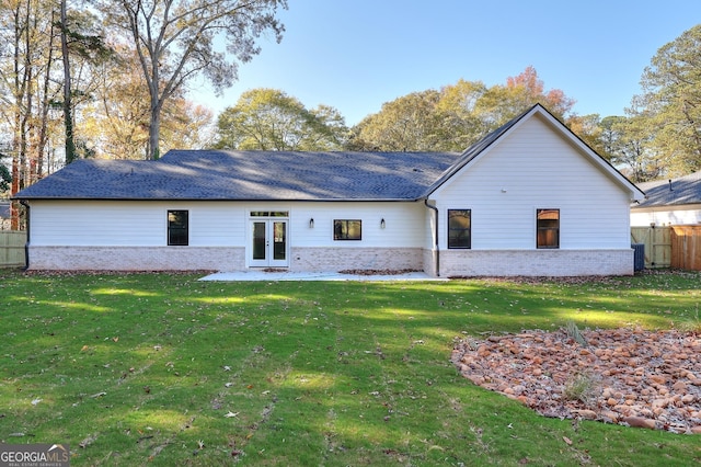 rear view of property with a yard and french doors