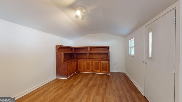 bonus room featuring light hardwood / wood-style floors and vaulted ceiling