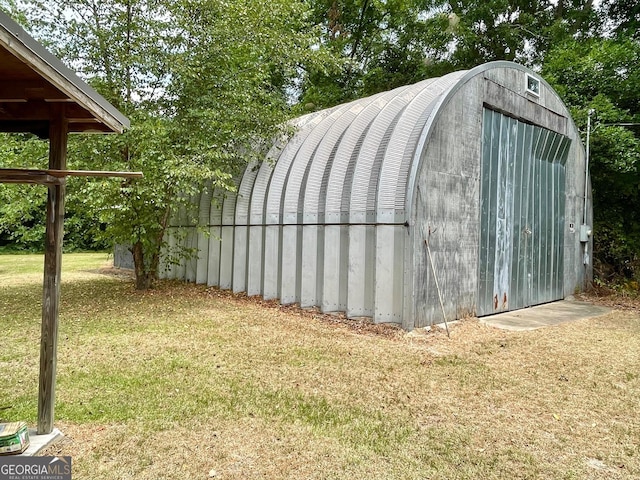 view of outbuilding featuring a lawn