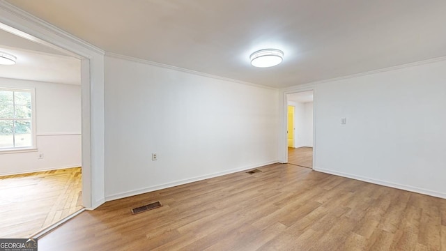 unfurnished room featuring light hardwood / wood-style flooring and ornamental molding