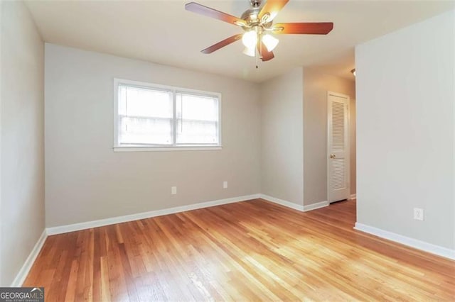 unfurnished room with light wood-type flooring and ceiling fan